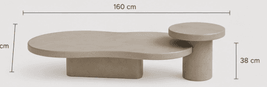 A contemporary, low-profile table featuring two interconnected surfaces of differing shapes and heights. The primary surface is a kidney-bean or organic-shaped top, supported by a rectangular plinth base. A secondary, circular top is slightly elevated and supported by a cylindrical base. The entire piece is rendered in a uniform light beige or greige color, suggesting a monolithic material like concrete, plaster, or a composite. The design emphasizes sculptural form and smooth, rounded edges. — 3D model