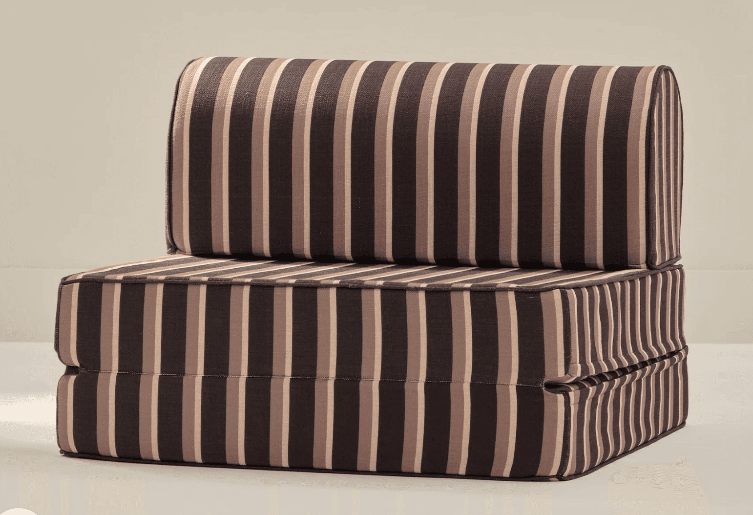 A sofa bed upholstered in fabric with a vertical stripe pattern. The furniture appears to be in a folded configuration, with the backrest section stacked on top of the seat/base section. The upholstery features alternating stripes of dark brown, light brown, and beige. The edges are trimmed with a darker piping. The overall construction suggests a modular or foldable design. — 3D model