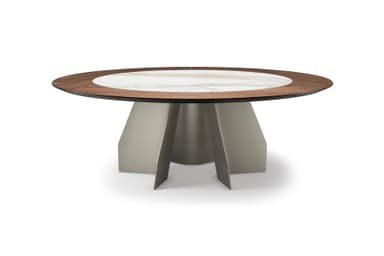 A modern dining table with a circular top featuring a central marble inlay surrounded by a dark wood veneer rim. The base is constructed from sculpted metal panels, creating an abstract, pedestal-like structure with intersecting planes. — 3D model