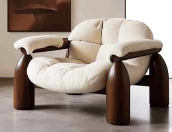 A sculptural lounge chair with a chunky dark wooden frame and plush cream-colored bouclé upholstery. The chair features rounded armrests and prominent, conical legs. The seat and backrest are deeply cushioned and appear to have a subtle tufted or segmented design. — 3D model