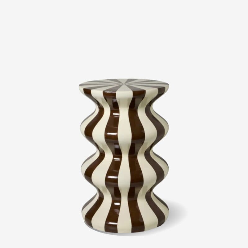A decorative ceramic stool featuring a wavy, hourglass-like silhouette adorned with bold brown and cream vertical stripes. The top surface displays a radial starburst pattern. It has a high-gloss glazed finish. — 3D model
