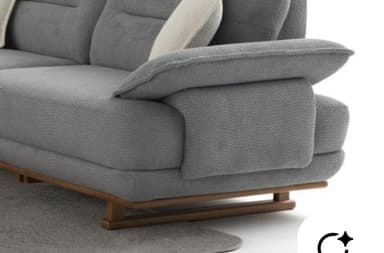 A modern, light grey upholstered lounge armchair featuring a textured fabric, wide padded armrests, and a supportive backrest with an additional decorative cushion. The chair sits on a visible wooden base frame with four tapered wooden legs. — 3D model