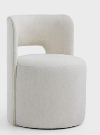 A contemporary fully upholstered barrel-shaped chair featuring a distinct curved back with a central rectangular cutout, covered in a light beige or off-white textured fabric. — 3D model