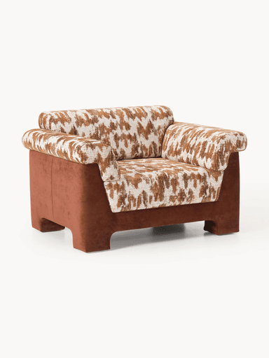 A single-seater armchair with a low profile and wide armrests. The seat and back cushions feature a textured geometric pattern in brown and off-white. The base and outer frame are upholstered in a solid, muted reddish-brown fabric. The armchair has a contemporary design with integrated block feet. — 3D model