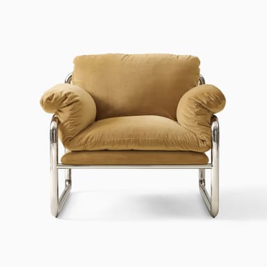 A modern armchair with a tubular chrome-plated steel frame and upholstered cushions. The frame forms a continuous loop supporting the seat, back, and armrests. The cushions appear to be filled with down or similar soft material, covered in a tan-colored fabric. — 3D model