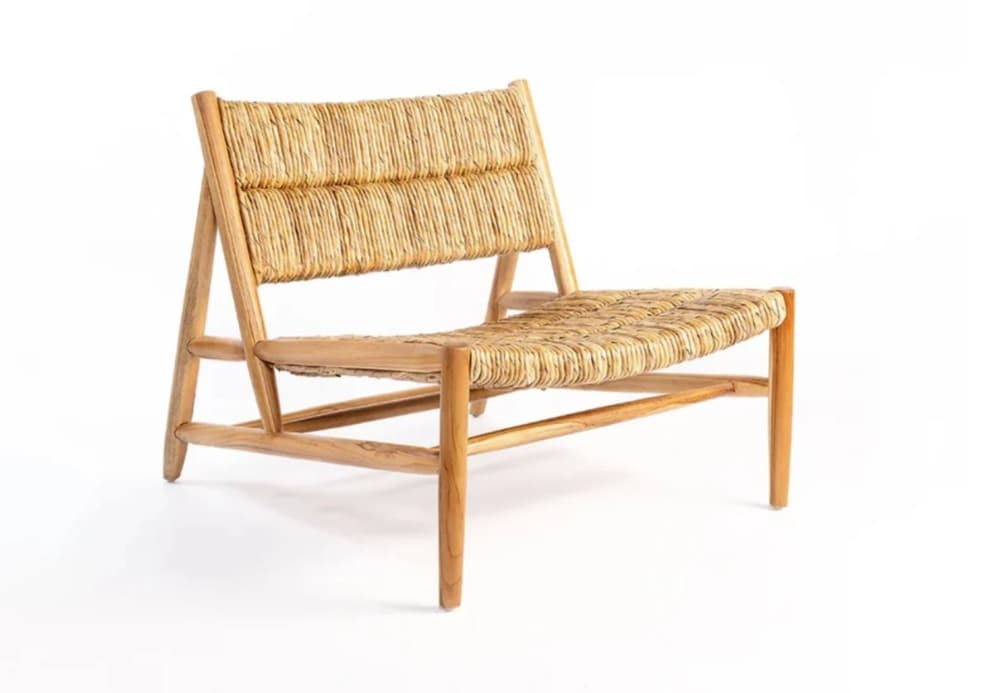 A low-profile lounge chair featuring a natural wood frame and a tightly woven rush or seagrass seat and backrest. — 3D model