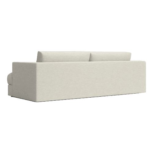 A cream-colored sofa seen from a rear three-quarter perspective. The sofa has a plush, upholstered design with two prominent back cushions. The base is a solid rectangular block, and the armrest on the visible left side is rounded and integrated into the main structure. The fabric appears to have a textured weave. — 3D model