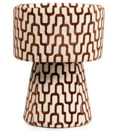 A modern armchair with a rounded, upholstered form. The chair features a high back that curves into armrests, enclosing the seating area. The base is a tapered pedestal, also upholstered, providing stability. The upholstery displays a geometric pattern of interlocking U-shapes in brown on an off-white background. — 3D model