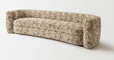 A curved sofa upholstered in a textured fabric with an abstract pattern. The sofa features rounded arms that seamlessly integrate into the backrest, creating a continuous, organic form. The seat is composed of a single cushion, and the backrest is also a continuous curve. The upholstery displays a mélange of colors including cream, beige, brown, and subtle hints of red and green. — 3D model