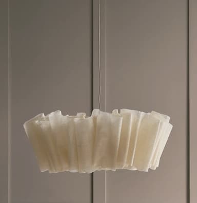 A sculptural pendant light featuring a pleated, light-colored, woven fabric shade suspended from the ceiling by a cord, emitting a warm, diffused light. — 3D model