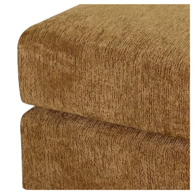 A rectangular upholstered ottoman featuring a textured golden-tan fabric. The design is a solid, block-like form with a slightly recessed base, giving it a sturdy, legless appearance. The upholstery has a subtle vertical pile texture across all visible surfaces. — 3D model