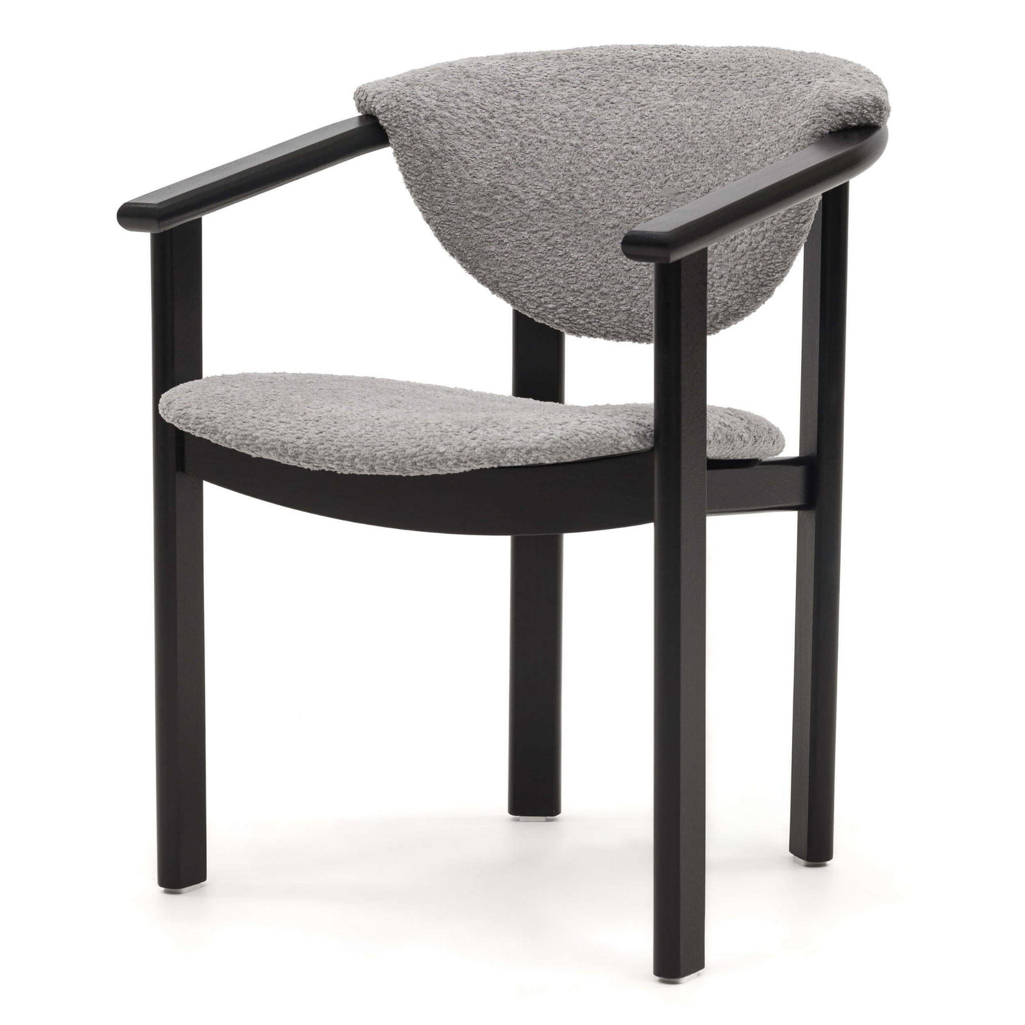 A modern armchair with a dark, angular frame and a curved, upholstered back and seat. The upholstery appears to be a textured, loop-pile fabric. The armrests are integrated into the frame, extending forward from the back legs and curving gently downwards to meet the front legs. The overall design is minimalist and contemporary. — 3D model