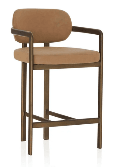 A contemporary bar stool featuring a sturdy metal frame with a bronzed finish, complemented by a padded seat and a gently curved backrest, both upholstered in a light brown fabric. The design includes integrated armrests and a footrest bar for comfort. — 3D model