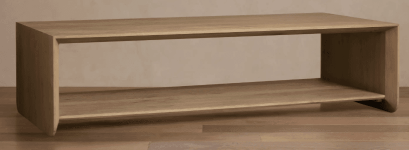 A minimalist, rectangular coffee table crafted from light-toned wood, featuring a continuous waterfall edge design for the top and side panels. It includes an integrated lower shelf, providing additional storage or display space. The design emphasizes clean lines and a contemporary aesthetic. — 3D model