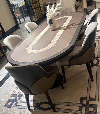 An oval conference table featuring a dark grey tabletop with a lighter, contrasting oval inlay, supported by two solid, rectangular panel bases. — 3D model