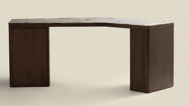 A dark wood corner desk with a marble-patterned top. The desk has a distinctive angular shape, with one side featuring a closed cabinet or drawer unit. The legs are thick and rectangular, with rounded edges. The top surface has a marbling pattern with grey and white tones on a dark base. — 3D model
