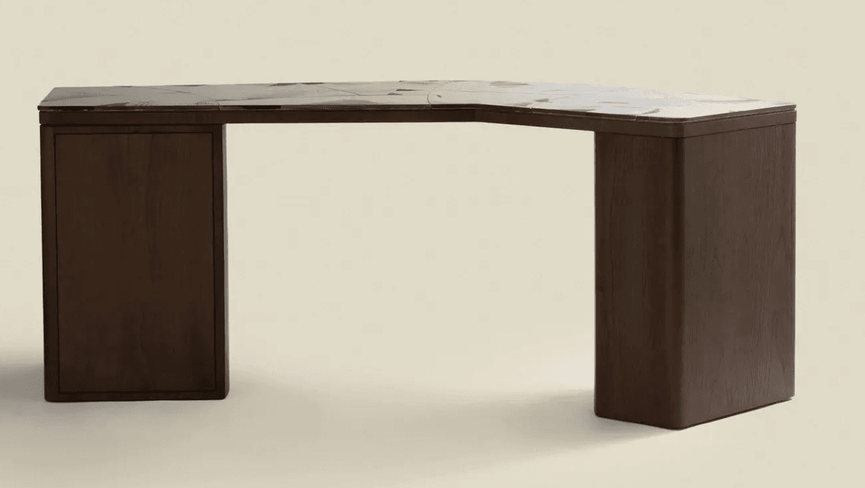 A dark wood corner desk with a marble-patterned top. The desk has a distinctive angular shape, with one side featuring a closed cabinet or drawer unit. The legs are thick and rectangular, with rounded edges. The top surface has a marbling pattern with grey and white tones on a dark base. — 3D model