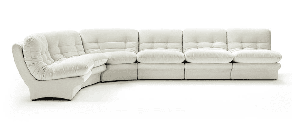 A modular sectional sofa with a curved corner element and multiple straight seating modules. The sofa features deep, plush cushions with a tufted pattern on the backrests and seat cushions. The upholstery appears to be a textured fabric. The base of the sofa is low-profile, with subtle curves on the corner piece. — 3D model