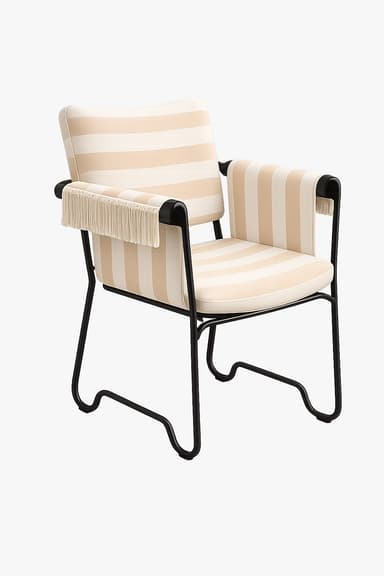 An upholstered accent armchair featuring wide vertical stripes in cream and beige, a black tubular metal frame, and decorative fringe details on the armrests. — 3D model