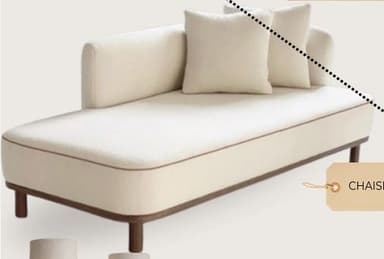 A contemporary chaise lounge featuring light cream bouclé-like upholstery with dark piping, supported by a minimalist dark wood frame and cylindrical legs. It has an asymmetrical design with a single raised backrest/armrest on one side and includes two matching throw pillows. — 3D model