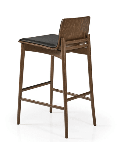 A modern bar stool featuring a dark-stained wooden frame, a gently curved wooden backrest, and a black upholstered seat. The stool has four tapered legs with integrated wooden footrests for stability and comfort. The overall aesthetic is clean and contemporary. — 3D model