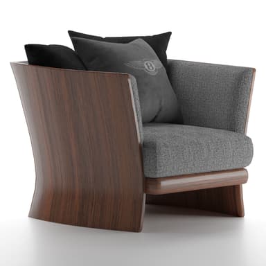 A sophisticated lounge chair featuring a distinctive dark wood frame that curves elegantly to form the back and sides, encasing a comfortable grey upholstered seat and backrest. The chair includes two black and one grey throw pillows, one of which features a winged logo, suggesting a luxury brand affiliation. — 3D model