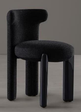 A contemporary accent chair featuring a chunky, sculptural form. The seat and backrest are upholstered in a textured black boucle fabric, with the backrest incorporating short, integrated armrests. The chair is supported by a combination of legs: two front legs are sleek, glossy black cylinders, while the rear legs are fully upholstered in the same black boucle fabric, extending directly from the chair's main structure. The design combines soft, tactile upholstery with smooth, reflective elements. — 3D model