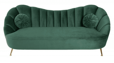 A dark green velvet sofa with a sculpted, fluted backrest and curved armrests. It features two round, tufted throw pillows. The sofa is supported by four slender, angled legs with a brass finish. — 3D model