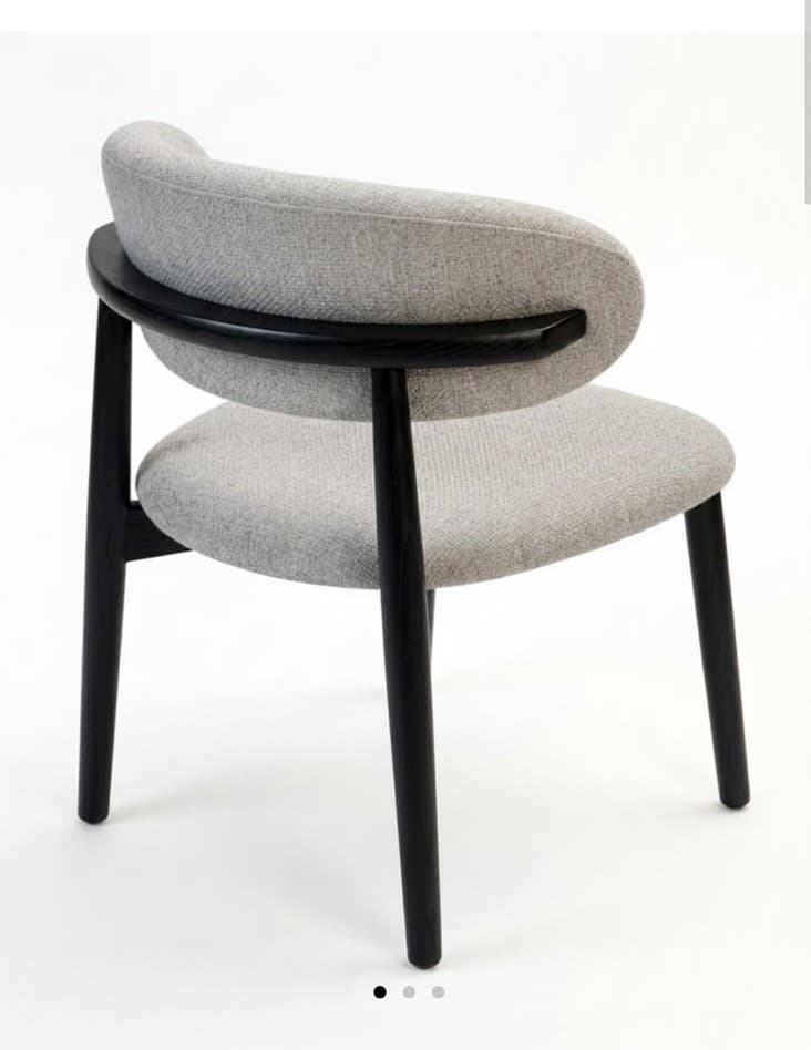 A contemporary dining chair featuring a light grey upholstered seat and a continuous, curved upholstered backrest that subtly integrates arm support. The chair is supported by four slender, slightly tapered legs crafted from dark, possibly black, stained wood. The design emphasizes clean lines and a minimalist aesthetic. — 3D model