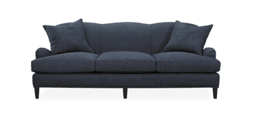 A three-seater sofa upholstered in a dark blue textured fabric. The sofa features a curved backrest with vertical channel tufting and rolled arms. It is supported by short, dark wooden legs. Decorative nailhead trim runs along the base of the sofa. Two throw pillows, matching the upholstery, are present, one on each end of the sofa. — 3D model