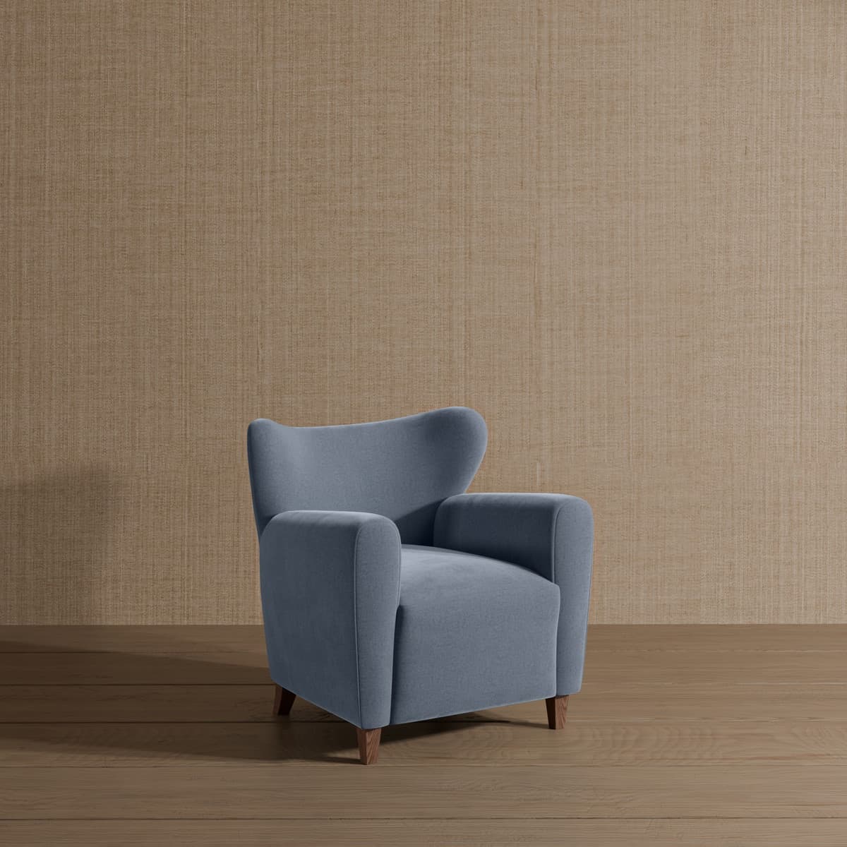 A single armchair with a high back and padded arms, upholstered in a soft blue fabric. It has four short, angled wooden legs. — 3D model