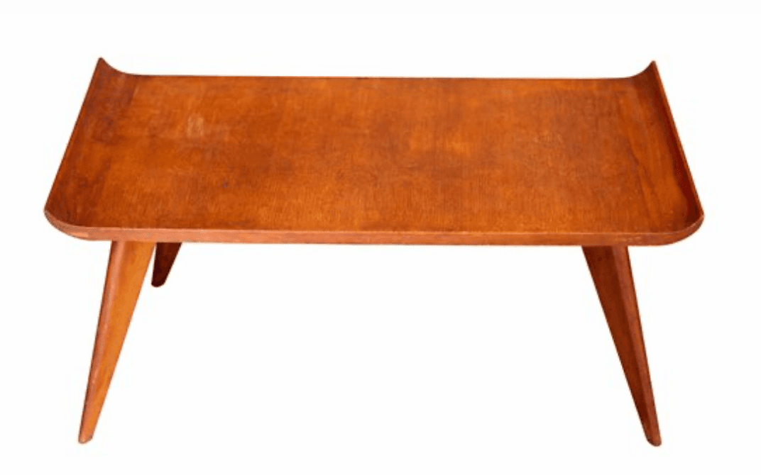 A mid-century modern coffee table with a rectangular, slightly curved wooden top and four tapered legs. The edges of the tabletop are subtly raised. — 3D model