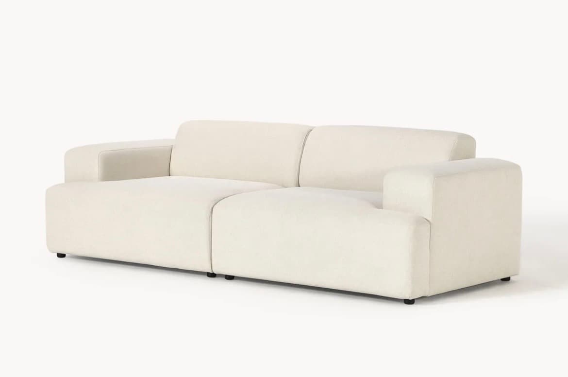 A contemporary modular two-seater sofa upholstered in a cream-colored, textured fabric, featuring integrated, rounded block arms and a low-profile design. — 3D model