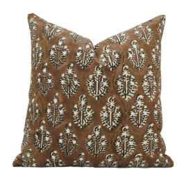 A square cushion with a brown base color and a repeating pattern of stylized floral or leaf motifs in white and black. The cushion appears to be slightly plumped and has a soft texture. The pattern is a block print style. — 3D model