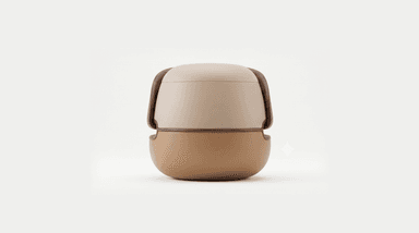 A compact, round, contemporary stool or ottoman. It features a two-tone upholstered body, with a lighter beige on the upper section and a warmer caramel brown on the lower, bulbous base. A thin wooden trim separates the two leather sections. A prominent, curved wooden handle in a dark wood tone arches gracefully over the top, creating a sculptural element and an opening beneath it. — 3D model