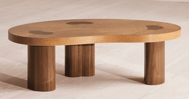 An organic modern coffee table featuring a distinct bean-shaped top crafted from a light-toned wood veneer with a radial sunburst pattern. The top is accented by several irregularly shaped, darker brown wood inlays. It is supported by three robust, dark wood cylindrical legs. — 3D model