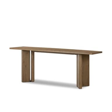 A minimalist side table constructed from solid wood, featuring a rectangular top and a base composed of thick vertical planks. The wood displays a natural grain and a medium brown finish, suggesting a rustic yet contemporary aesthetic. The base has a split, slatted design, offering a unique architectural element. — 3D model