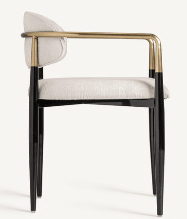 A modern armchair with a gently curved back and seat, upholstered in a textured light-colored fabric. The chair features sleek, tapered legs in black, and its armrests are formed by a continuous metal tube with a brass finish, attached to the frame. — 3D model