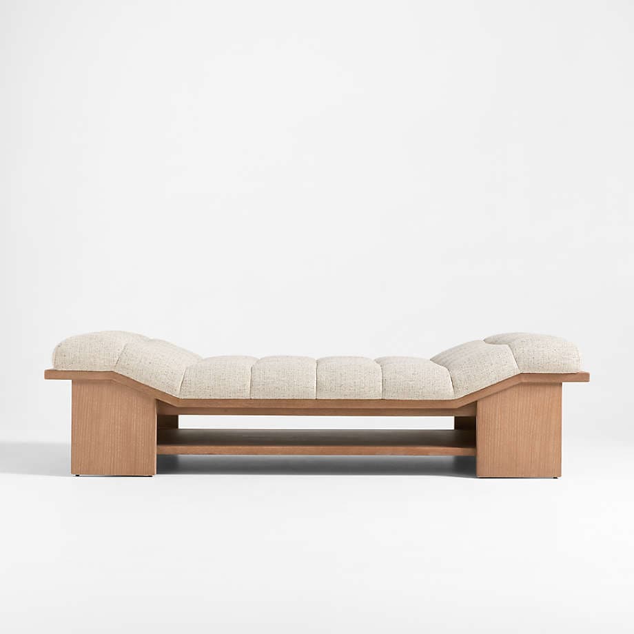 A modern bench with a curved, tufted upholstered seat and a slatted wooden frame. The base features a lower shelf for storage or display. The design incorporates clean lines with a natural wood finish and textured upholstery. — 3D model