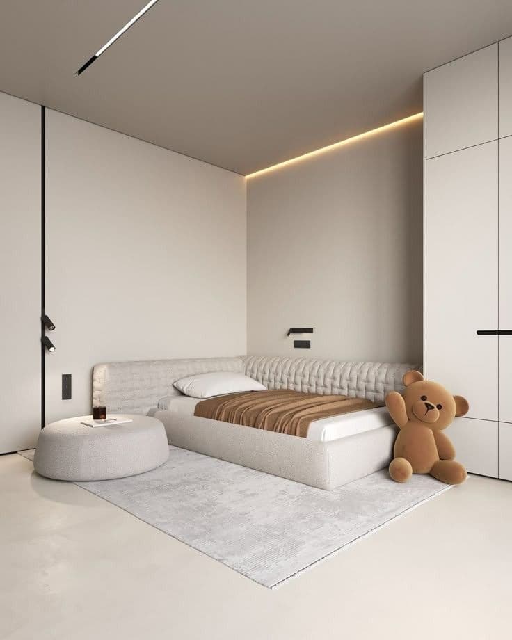 A single upholstered bed featuring an integrated, textured headboard and side rail, accompanied by a matching upholstered round ottoman. — 3D model