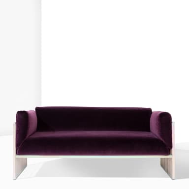 A modern sofa featuring a deep purple velvet upholstered seat and back, with rounded armrests. The frame and legs are constructed from polished metal, presenting a slatted design on the sides and base, giving it a distinct industrial or contemporary aesthetic. — 3D model
