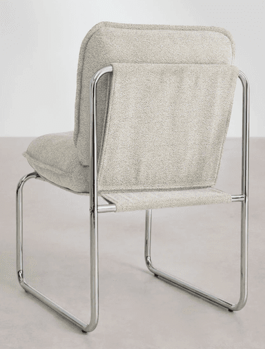 A modern armchair with a tubular metal frame and upholstered seat and back. The frame is constructed from polished chrome tubular steel, forming a cantilevered base and armrests. The seat and backrest are padded and covered in a textured, light grey fabric with a visible weave. The backrest appears to be a single piece of fabric stretched taut between the metal supports, while the seat is a separate cushion. — 3D model