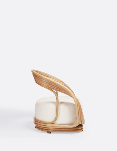 A contemporary accent chair featuring a unique sculptural frame crafted from light-toned rattan or bentwood, paired with a circular, upholstered seat in a textured off-white fabric. The frame creates a distinct backrest and wraps around the base, giving the chair an organic and modern aesthetic. — 3D model