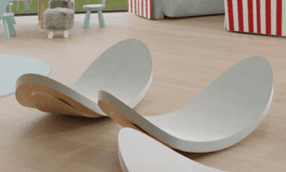 A modern, curved shelf with a light gray finish on the top and an exposed natural wood edge. The shelf appears to be made of a composite material, possibly wood or MDF, with a veneer or painted surface. — 3D model