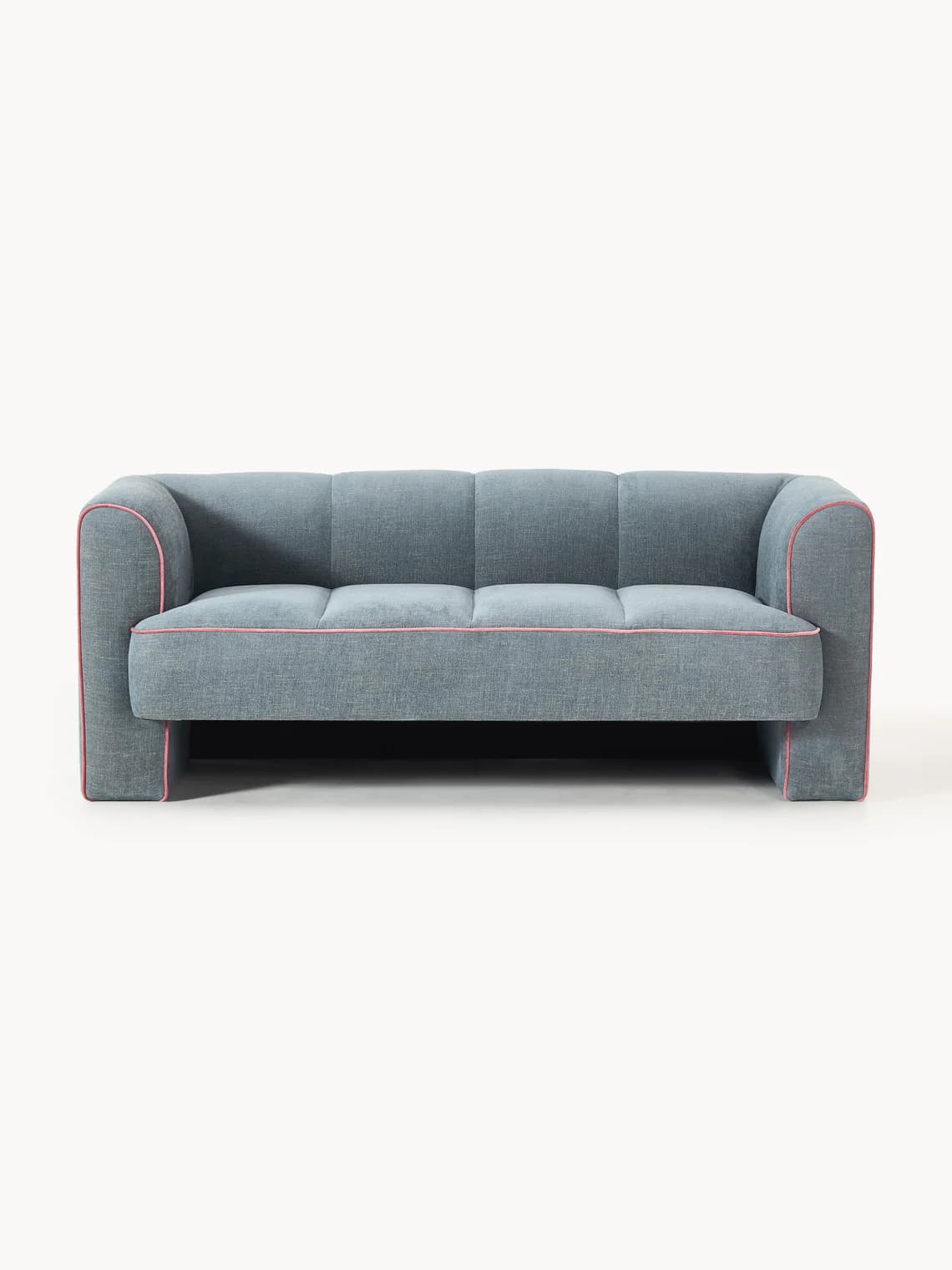 A contemporary three-seater sofa upholstered in a blue-grey textured fabric, featuring distinct pink piping along its edges, outlining the seat cushions, backrest, and arms. The sofa has a low-profile, integrated design with block-style armrests and a continuous backrest that blends into the frame. The base is also upholstered, giving it a solid, grounded appearance without visible legs. — 3D model