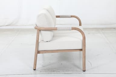 A two-seater sofa with a light-colored wooden frame and light-colored fabric upholstery. The frame features curved armrests and a simple rectangular base. The seat and back cushions are separate and appear to be filled with a soft material. — 3D model