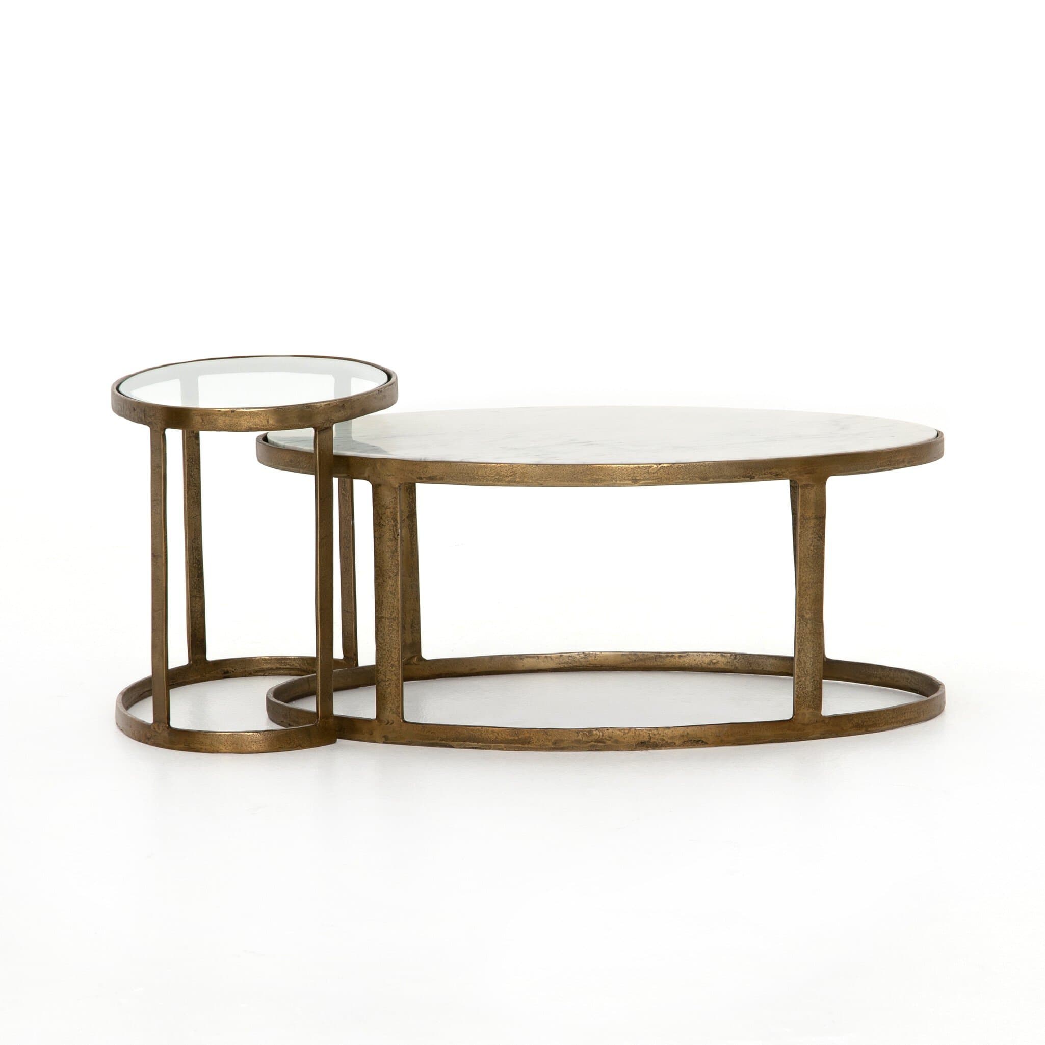 A nesting set of two coffee tables with oval tops. The larger table has an oval top and a base constructed from curved metal rods forming an elliptical shape. The smaller, nesting table has a round top and a similar metal base structure, designed to fit partially beneath the larger table. Both table tops appear to be made of a white veined material, likely marble or a marble-like composite, and are set within a metal frame. — 3D model