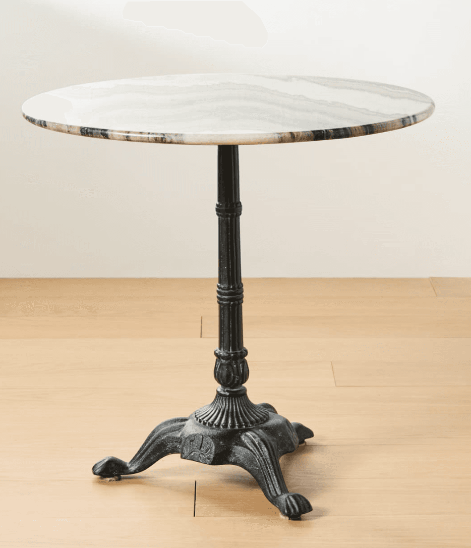 A round table featuring a polished white marble top with natural grey veining, supported by a dark, ornate cast iron pedestal base with decorative detailing and four splayed, paw-like feet. — 3D model