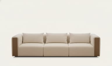 A close-up view of a modern sofa armrest and seat cushion. The sofa features clean lines, plush cushioning, and subtle stitching details. The armrest is upholstered in a light beige material with vertical decorative stitching and a contrasting darker beige accent panel on the side. A matching throw pillow is visible on the seat. — 3D model