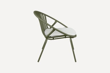 A modern armchair with a rounded, slatted back and seat, featuring a minimalist design. The frame is constructed from slender metal tubing, and it includes a white cushion for comfort. The chair is supported by four thin legs. — 3D model